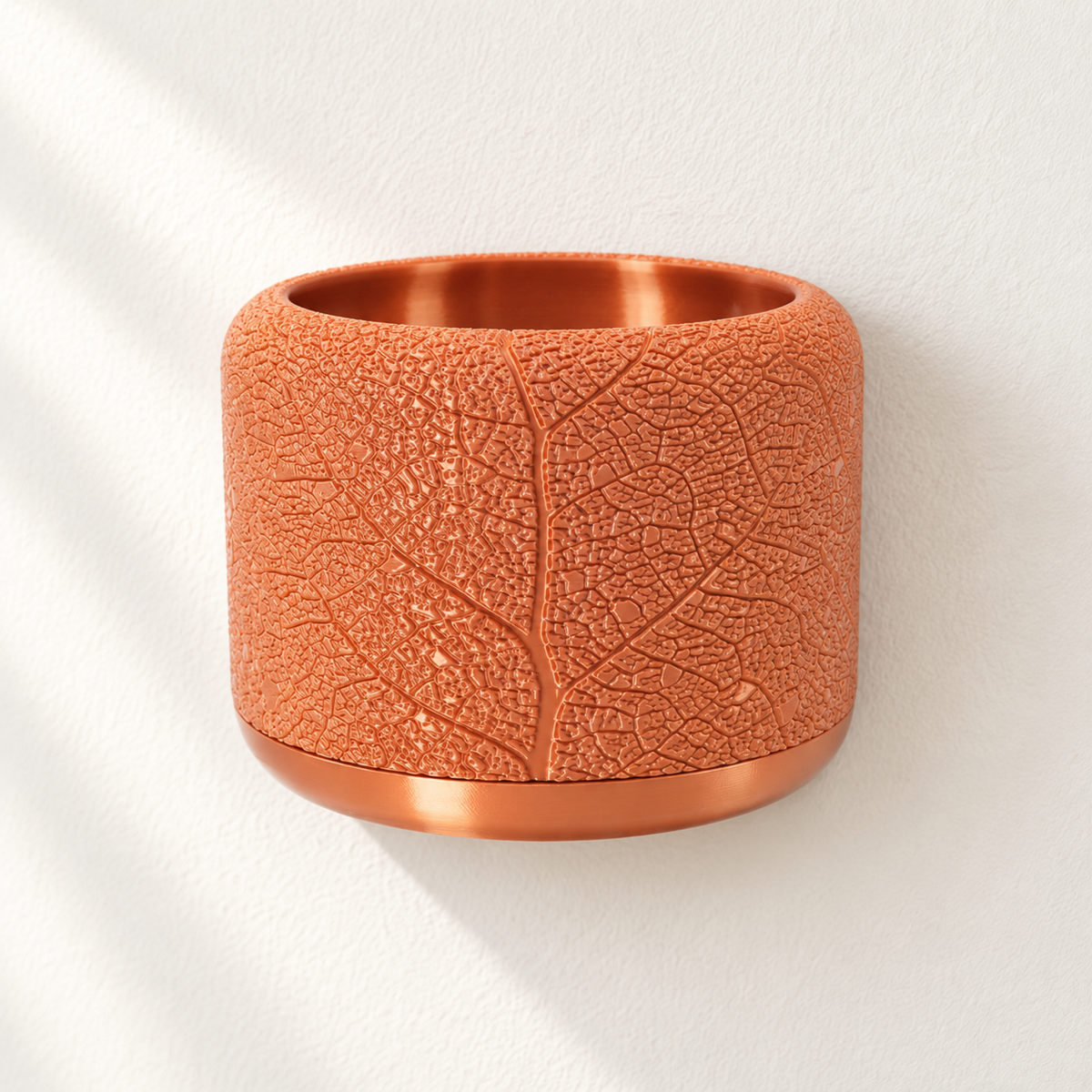 Empty copper-colored Leaf Vein wall planter with branching leaf relief and a smooth lower band.