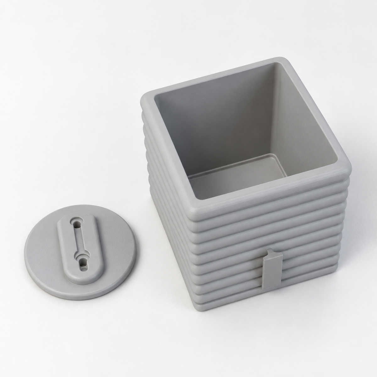Gray Seno planter viewed from above and behind beside its separate oval wall bracket.