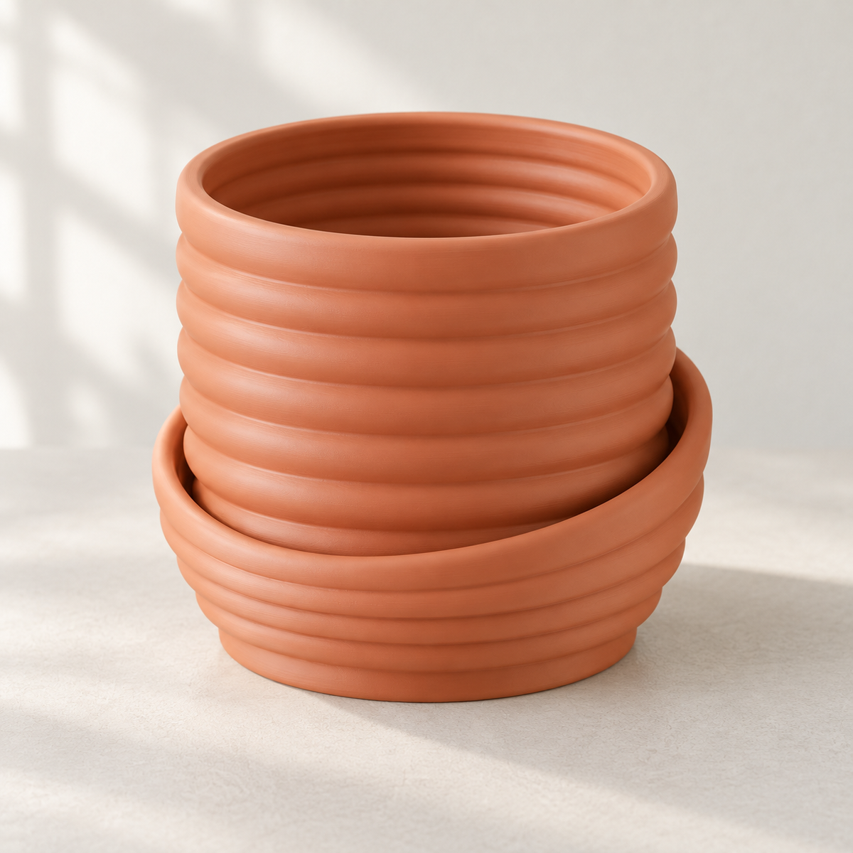 Angled view into the empty Viren wall planter with rounded horizontal bands and an offset lower sweep.