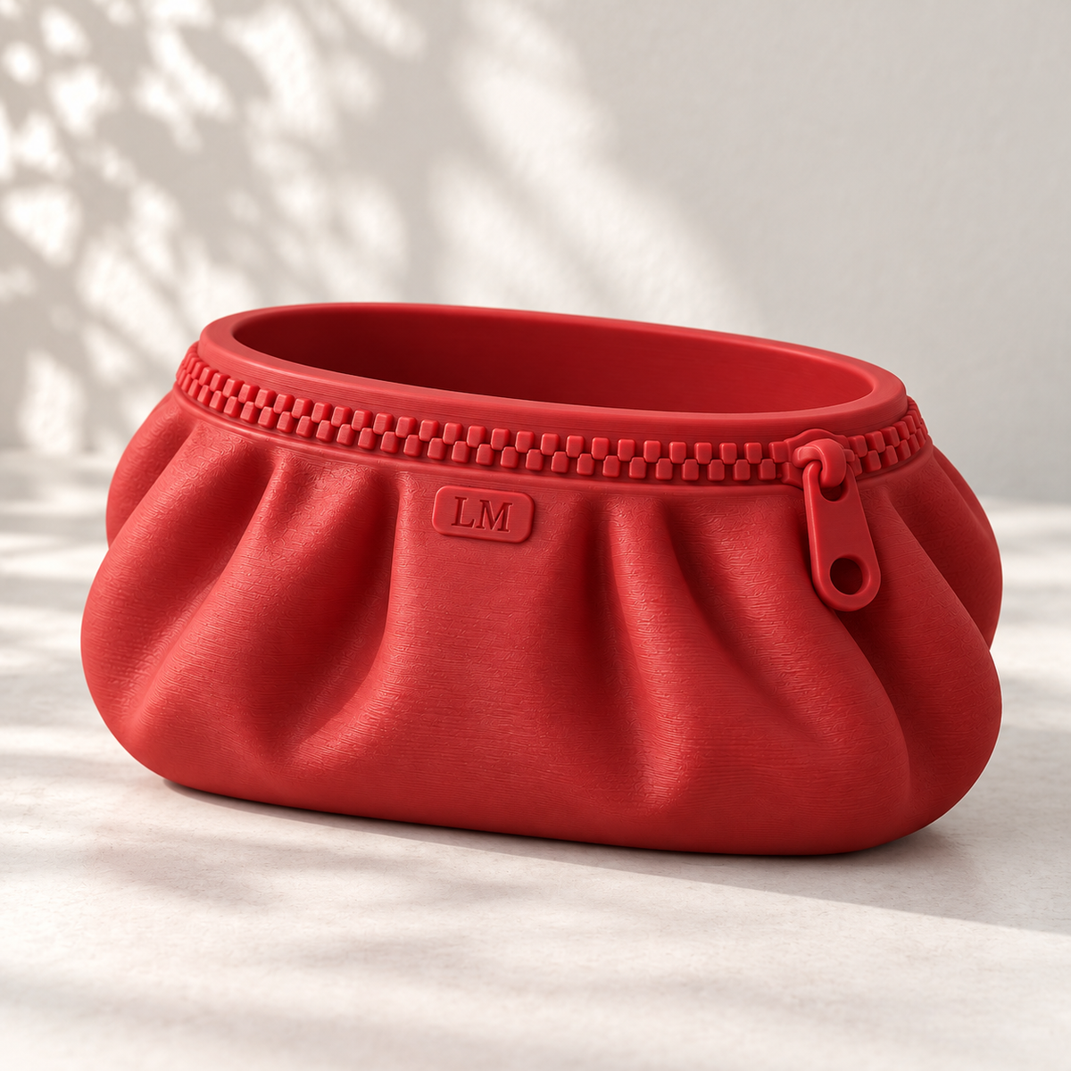 Red Zipra pouch planter with LM initials, oval opening and decorative zipper